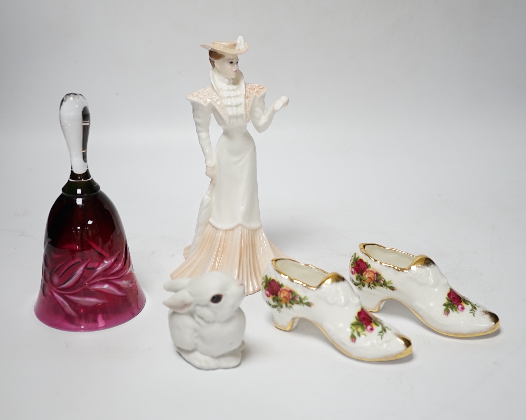 A small group of figurines and decorative ceramics, including four floral ceramic table displays